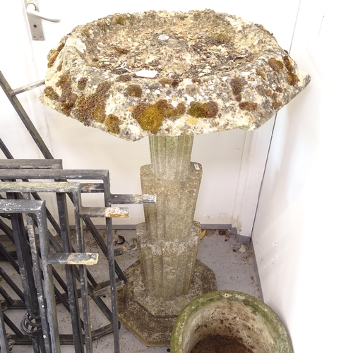 2745 - A weathered concrete birdbath, on an Art Deco style column support, W65cm, H107cm