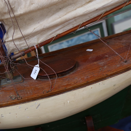 764 - A Victorian green and white painted pond yacht, with masts and sails, on fitted stand, length overal... 