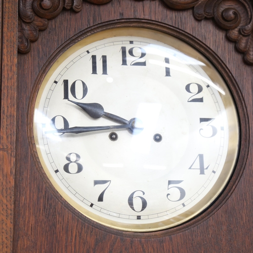 778 - A Continental oak-cased wall clock, with 2-train movement, height 71cm