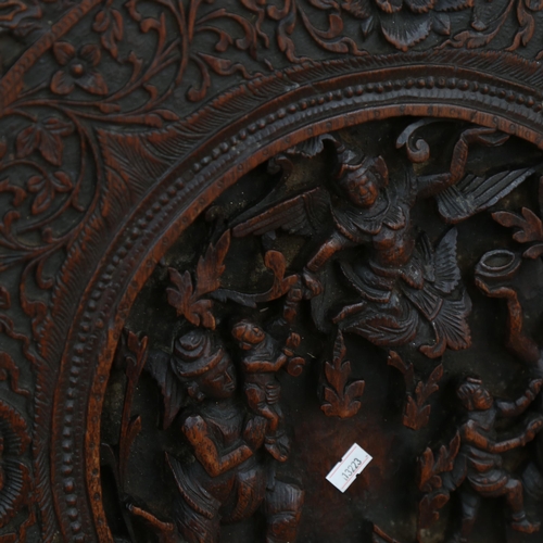 779 - An elaborately carved Eastern panel, depicting an angel and figures, height 62cm