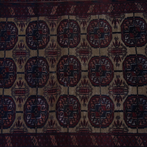 2401 - A red ground Tekki design rug, 122cm x 95cm