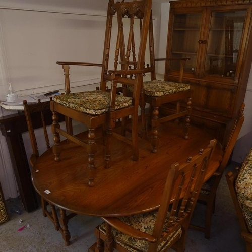 2733 - An Ercol elm lounge and dining room suite, comprising an oval table with 8 matching elbow chairs, 2 ... 