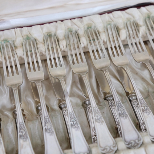 1031 - A cased set of German silver dessert knives and forks for 12 people, Art Nouveau foliate decoration,... 