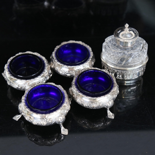 1063 - A set of 4 Edwardian silver salt cellars, relief embossed floral decoration, with blue glass liners,... 