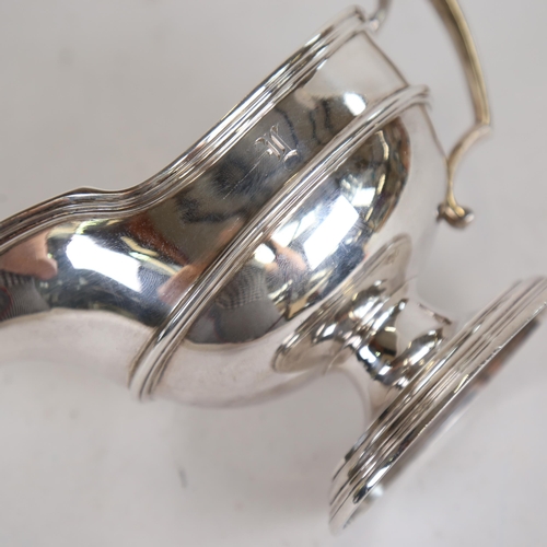 1070 - WITHDRAWN:An Edwardian silver pedestal sauce boat, reeded rim, with scrolled handle, by Elkington & ... 