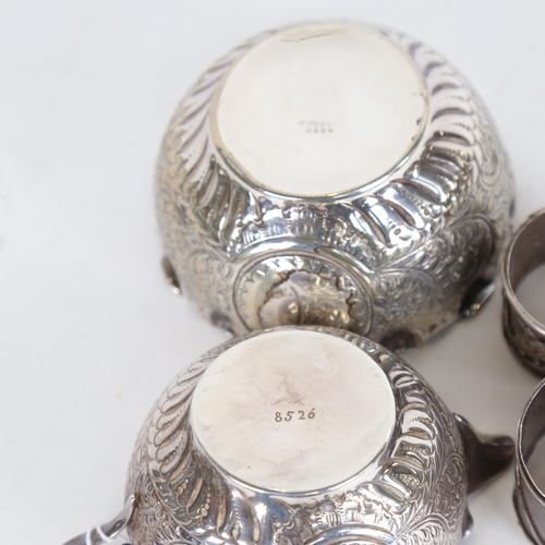 919 - 2 Chinese export silver napkin rings, with embossed decoration, by Wang Hing and Luen Hing, and an e... 