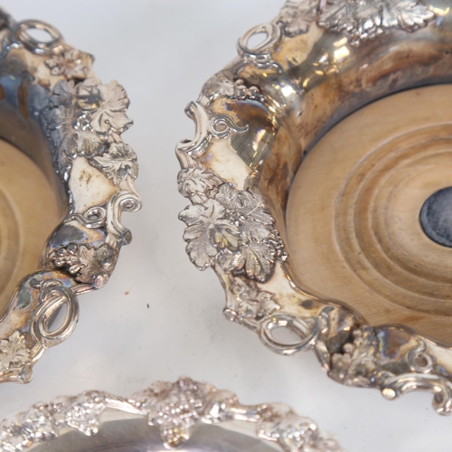 921 - A pair of silver plated wine coasters, with grape and leaf embossed decoration, and another (3)