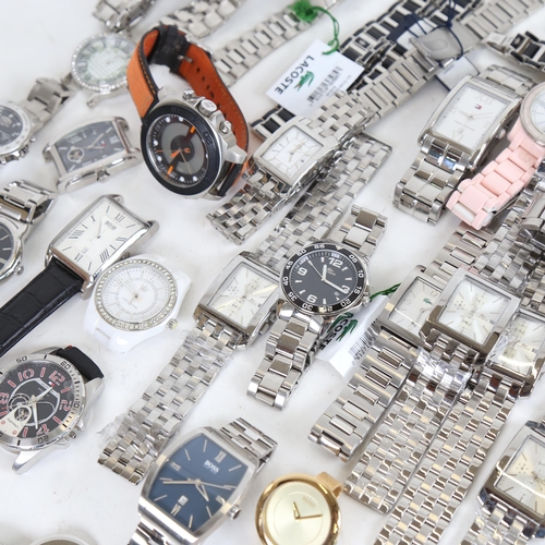 993 - A large quantity of designer wristwatches, including Tommy Hilfiger, Hugo Boss, Lacoste, and Juicy C... 