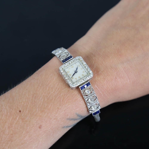 11 - A lady's Art Deco sapphire and diamond cocktail wristwatch, set with calibre cut sapphires and old a... 