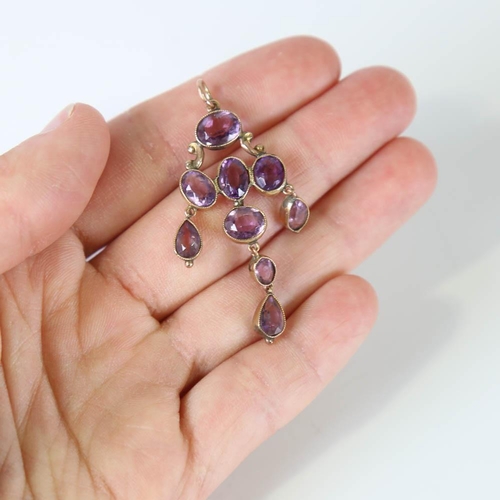 108 - A Victorian amethyst pendant, unmarked yellow metal settings with oval and pear cut amethysts, penda... 