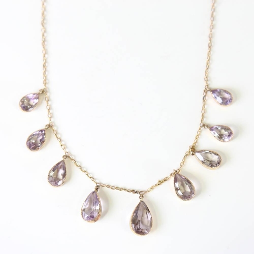 109 - An Edwardian 9ct gold graduated amethyst fringe necklace, set with pear cut amethysts, on a cable li... 