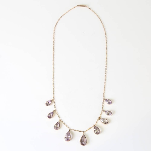 109 - An Edwardian 9ct gold graduated amethyst fringe necklace, set with pear cut amethysts, on a cable li... 