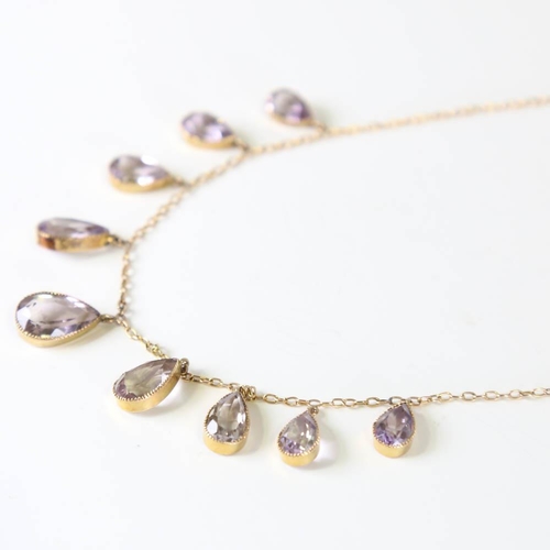 109 - An Edwardian 9ct gold graduated amethyst fringe necklace, set with pear cut amethysts, on a cable li... 