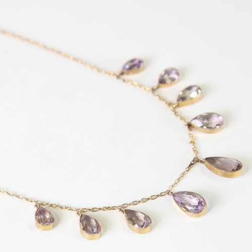 109 - An Edwardian 9ct gold graduated amethyst fringe necklace, set with pear cut amethysts, on a cable li... 