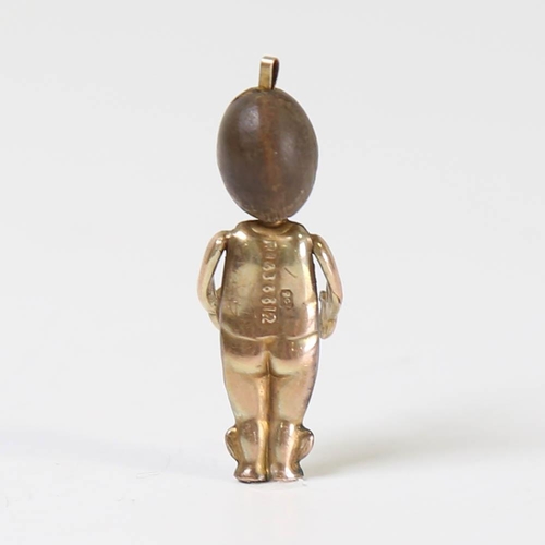 110 - A First World War Period 9ct gold Fumsup good luck charm, with carved wood head, inset glass eye and... 