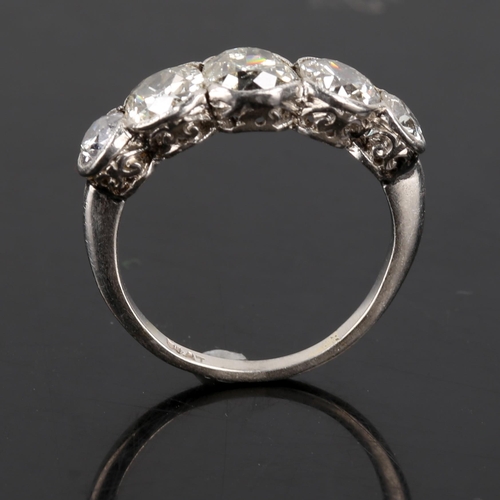 119 - A mid-20th century platinum graduated 5-stone diamond ring, bezel set with old European cut diamonds... 