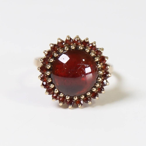 130 - A late 20th century 9ct gold garnet cluster ring, set with round cabochon garnet surrounded by round... 