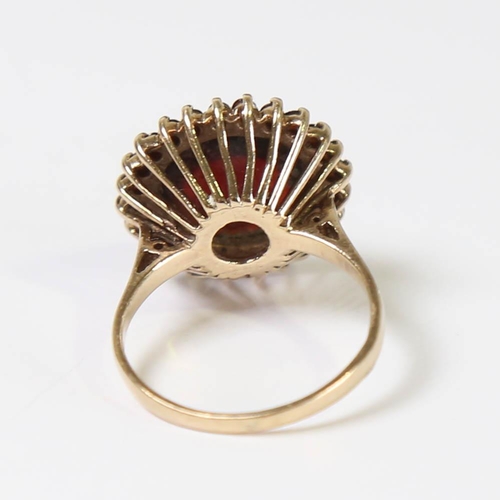 130 - A late 20th century 9ct gold garnet cluster ring, set with round cabochon garnet surrounded by round... 