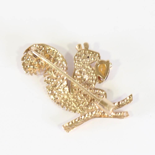 137 - A late 20th century 9ct gold figural squirrel brooch, modelled holding a pear cut citrine, with a sa... 