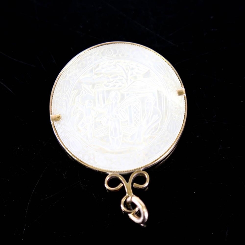 139 - A Chinese mother of pearl gaming counter pendant, in 9ct gold frame, crest decoration with 