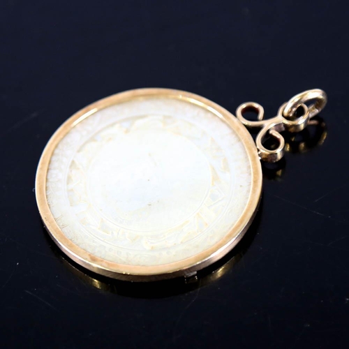 139 - A Chinese mother of pearl gaming counter pendant, in 9ct gold frame, crest decoration with 