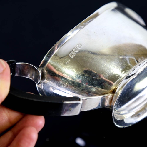 141 - A pair of George VI Art Deco silver sauce boats, stylised form with ebonised handles, by S Blanckens... 