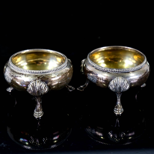 143 - A pair of Victorian silver salt cellars, beaded edge with hoof feet and gilt interior, by James Beeb... 