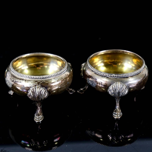 143 - A pair of Victorian silver salt cellars, beaded edge with hoof feet and gilt interior, by James Beeb... 