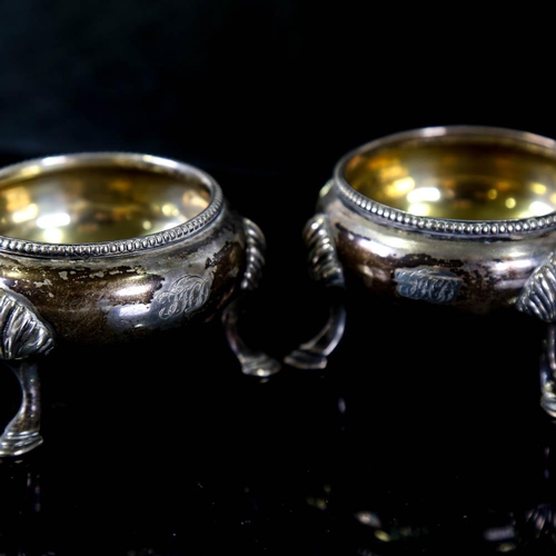 143 - A pair of Victorian silver salt cellars, beaded edge with hoof feet and gilt interior, by James Beeb... 