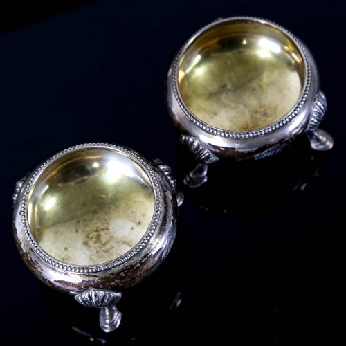 143 - A pair of Victorian silver salt cellars, beaded edge with hoof feet and gilt interior, by James Beeb... 