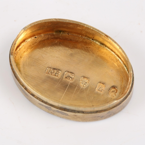 165 - A George III silver gilt vinaigrette, plain oval form with removable grille, by Roger Biggs, hallmar... 