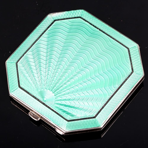 170 - An Art Deco style George VI silver and green enamel compact, octagonal form with engine turned sunbu... 