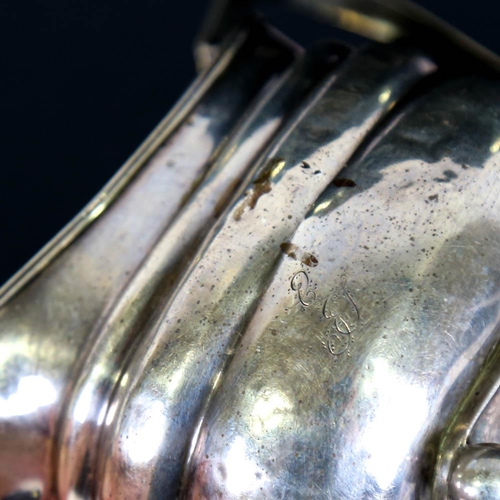 185 - A Georgian silver cream jug, bulbous form with reeded rim and bun feet, maker's marks IR IW, height ... 