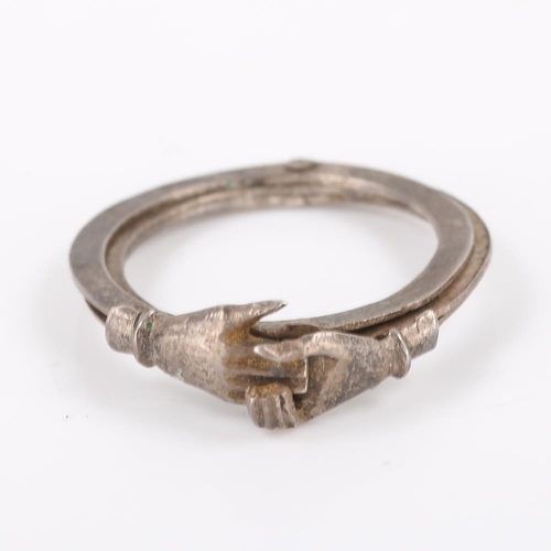 195 - A Victorian silver Fede Gimmel ring, triple swivel band with two clasped hands opening to reveal a h... 