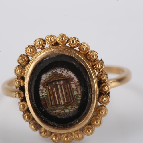 197 - An Antique Grand Tour micro mosaic panel dress ring, depicting ruins within a cannetille surround, s... 