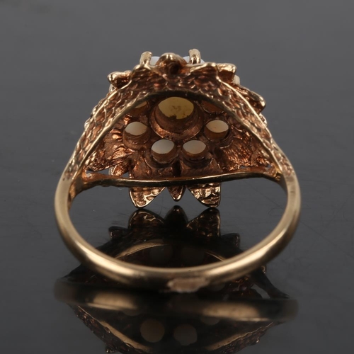 198 - A late 20th century 9ct gold opal cluster flowerhead ring, textured leaf surround set with round cab... 