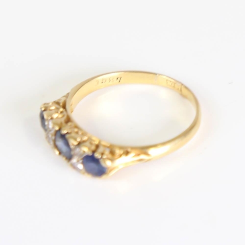 203 - An early 20th century 18ct gold 7-stone sapphire and diamond half hoop ring, set with round cut sapp... 