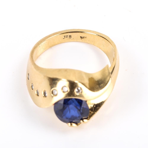 206 - A modern Continental 14ct gold synthetic sapphire and diamond crossover ring, heavy wraparound setti... 