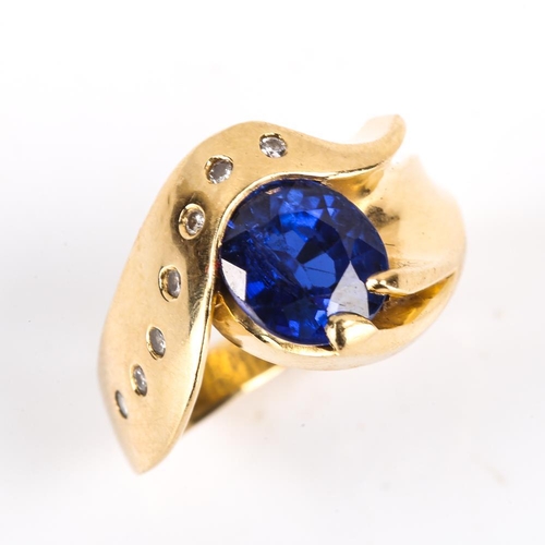 206 - A modern Continental 14ct gold synthetic sapphire and diamond crossover ring, heavy wraparound setti... 