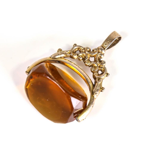 208 - A large Victorian 9ct gold citrine swivel fob, openwork and engraved foliate decoration, citrine len... 