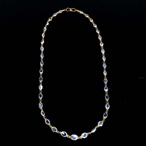 211 - A modern handmade 14ct gold blue moonstone line necklace, set with graduated oval cabochon moonstone... 