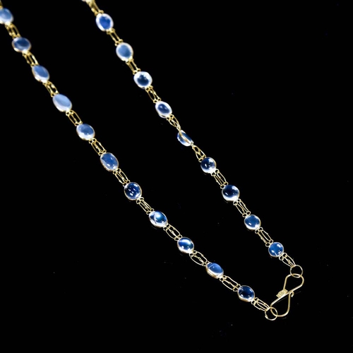 211 - A modern handmade 14ct gold blue moonstone line necklace, set with graduated oval cabochon moonstone... 