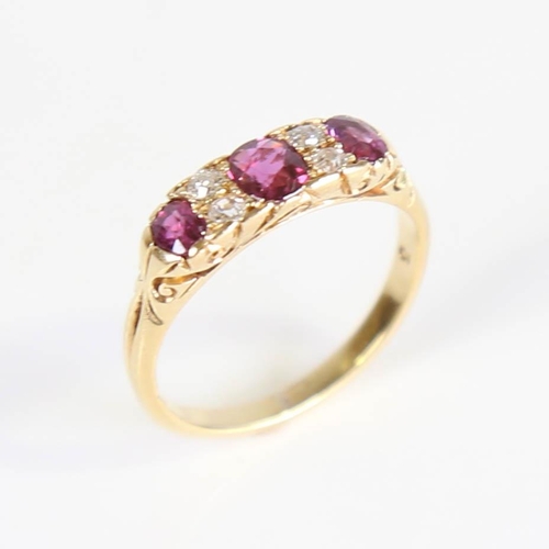 214 - An early 20th century 18ct gold 7-stone ruby and diamond half hoop ring, set with oval mixed cut rub... 