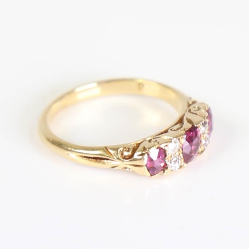 214 - An early 20th century 18ct gold 7-stone ruby and diamond half hoop ring, set with oval mixed cut rub... 