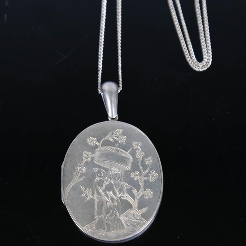 355 - A Victorian Chinoiserie locket pendant necklace, unmarked white metal settings with engraved figural... 