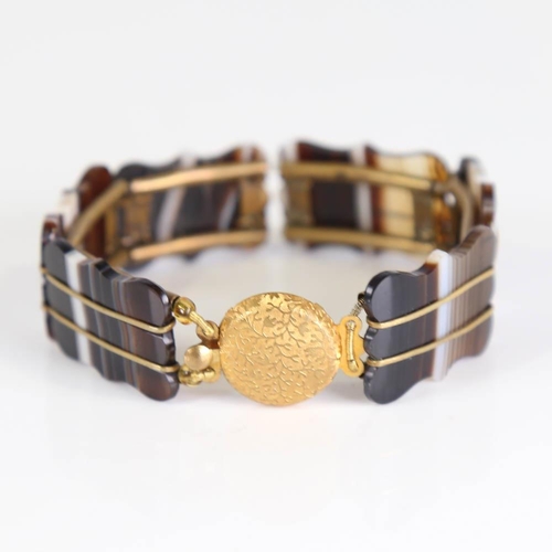 356 - A Scottish banded agate panel bracelet, gilt metal settings with floral clasp, bracelet length 17cm,... 