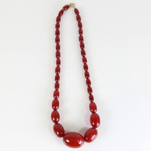 358 - A graduated single-row cherry amber bead necklace, on gilt metal clasp, beads measuring from 13.2mm ... 