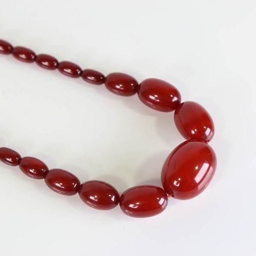 358 - A graduated single-row cherry amber bead necklace, on gilt metal clasp, beads measuring from 13.2mm ... 