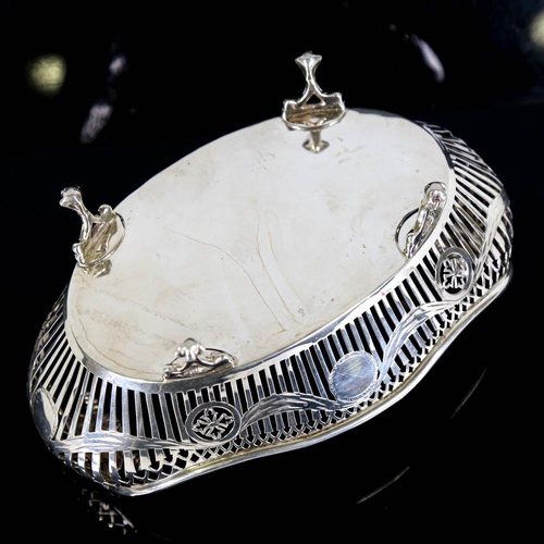 359 - A George V silver cake basket, oval form with scrolled handles, pierced gallery and engraved Adam's ... 