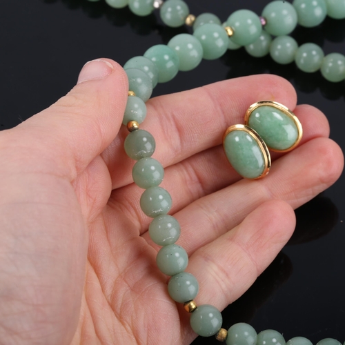 366 - A Chinese single-row polished jade bead necklace, and a similar pair of jade stud earrings, necklace... 